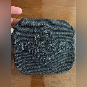 Beaded gray clutch with magnet closure.